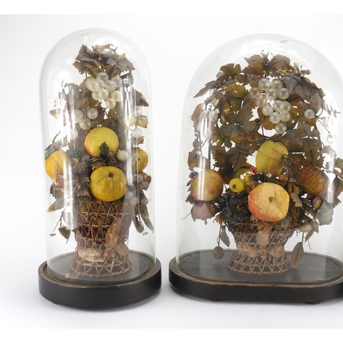 109 - Three Victorian wax fruit displays, each housed under glass domes raised on ebonised wood stands, th... 