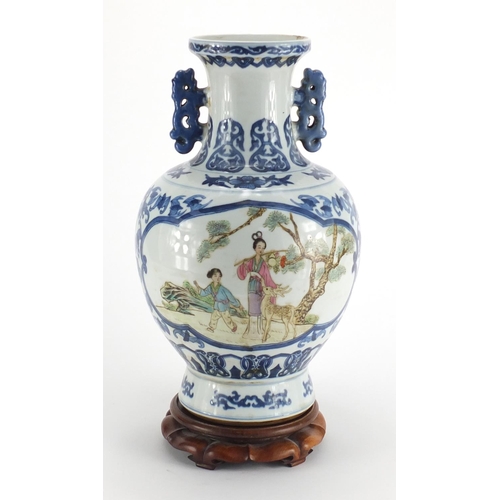 540 - Chinese blue and white porcelain vase, with twin handles raised on hardwood stand, the two central p... 