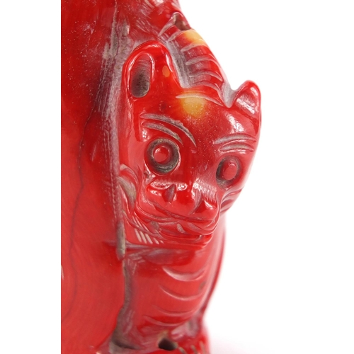 694 - Chinese carved coral double lion snuff bottle with stoppers, 10cm high