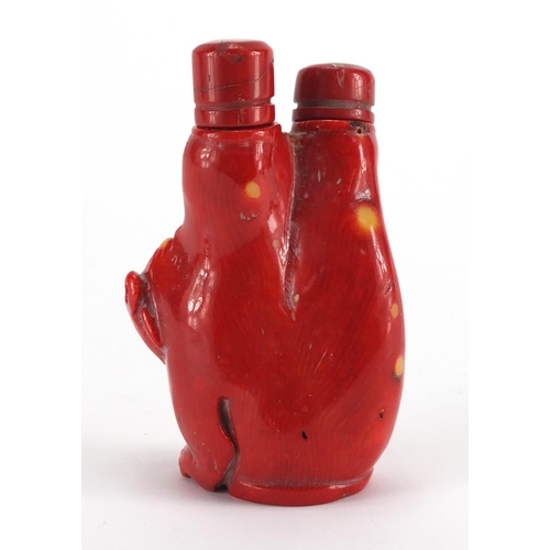 694 - Chinese carved coral double lion snuff bottle with stoppers, 10cm high