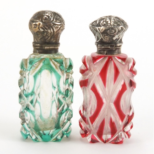 8 - Two Victorian flashed cut glass scent bottles with unmarked silver mounts, one with stopper, the lar... 