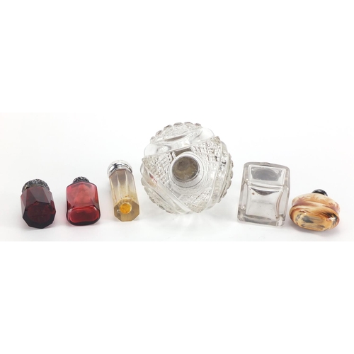9 - Six silver mounted scent bottles including a globular cut glass example and two faceted ruby example... 
