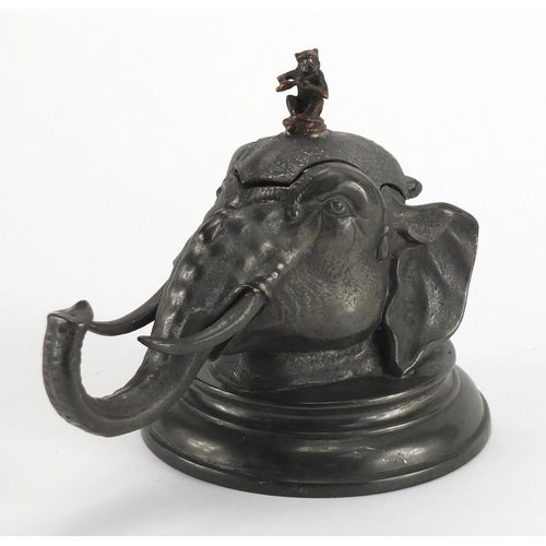 91 - Novelty pewter elephant head design inkwell with glass liner, 14cm high