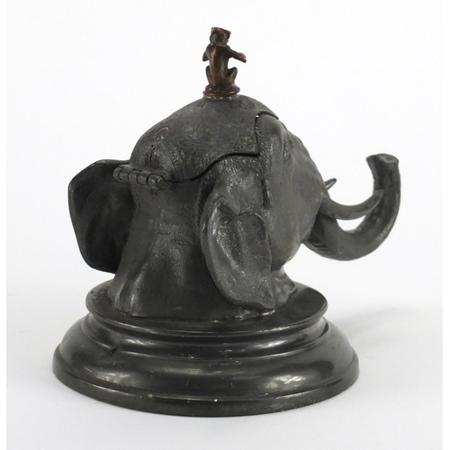 91 - Novelty pewter elephant head design inkwell with glass liner, 14cm high