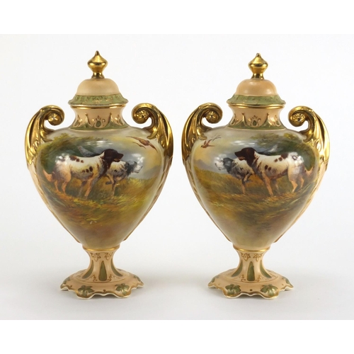 943 - Pair of Crown Devon vases and covers with twin gilt handles, each hand painted with Spaniels and phe... 