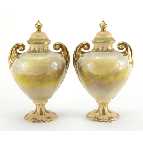 943 - Pair of Crown Devon vases and covers with twin gilt handles, each hand painted with Spaniels and phe... 