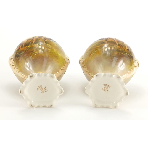 943 - Pair of Crown Devon vases and covers with twin gilt handles, each hand painted with Spaniels and phe... 