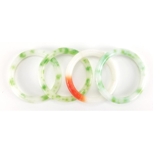 698 - Four Chinese white, green and red jade bangles, the largest approximately 8cm in diameter, approxima... 