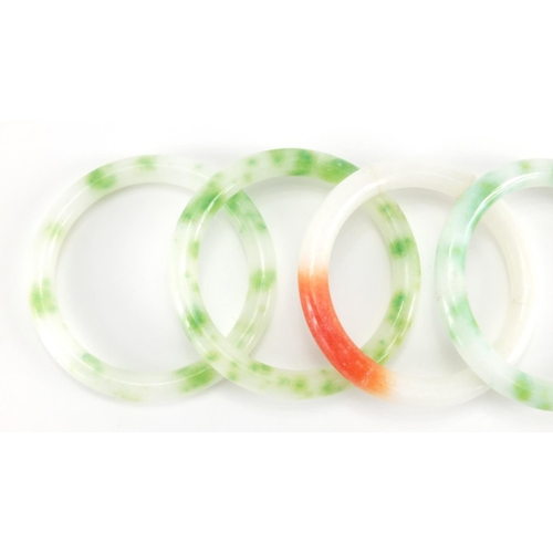 698 - Four Chinese white, green and red jade bangles, the largest approximately 8cm in diameter, approxima... 