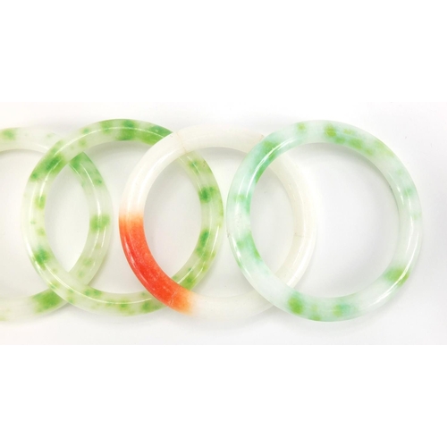 698 - Four Chinese white, green and red jade bangles, the largest approximately 8cm in diameter, approxima... 