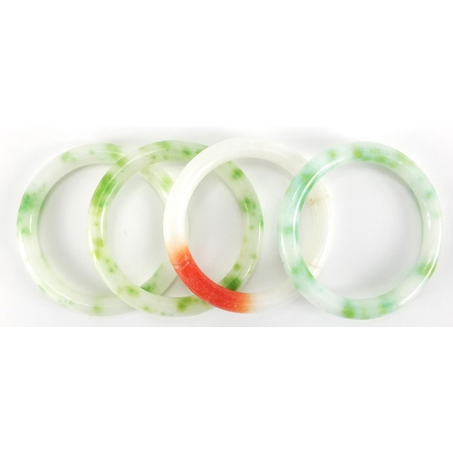 698 - Four Chinese white, green and red jade bangles, the largest approximately 8cm in diameter, approxima... 