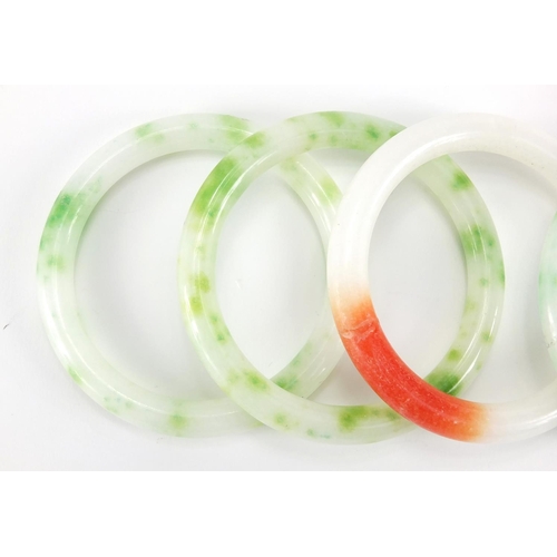 698 - Four Chinese white, green and red jade bangles, the largest approximately 8cm in diameter, approxima... 