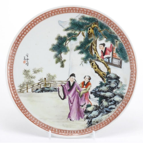 572 - Chinese porcelain footed plate, hand painted in the famille rose palette with three figures in a pav... 