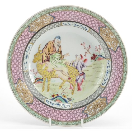 558 - Chinese porcelain shallow dish, hand painted in the famille rose palette with a central panel of two... 
