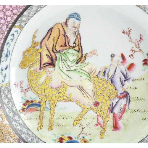 558 - Chinese porcelain shallow dish, hand painted in the famille rose palette with a central panel of two... 