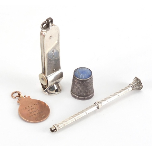 44 - Miscellaneous objects including a 9ct gold and enamel dart jewel, silver cigar cutter and silver and... 