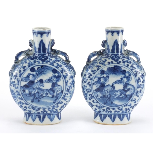549 - Pair of Chinese blue and white moon flasks with twin handles, each hand painted with warriors and fi... 