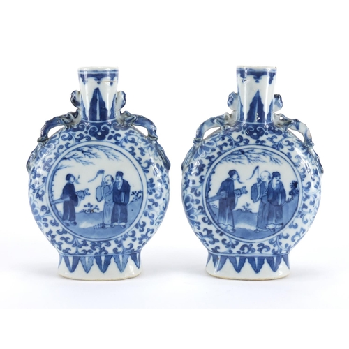 549 - Pair of Chinese blue and white moon flasks with twin handles, each hand painted with warriors and fi... 
