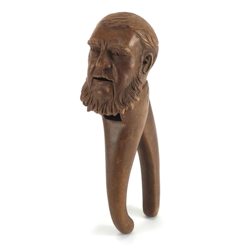 66 - Pair of Black Forest nut crackers carved as a bearded gentleman, 21cm in length