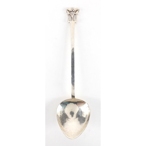 1040 - Arts & Crafts hammered silver spoon with fig shaped bowl and stylised floral finial, by A E Jones, B... 