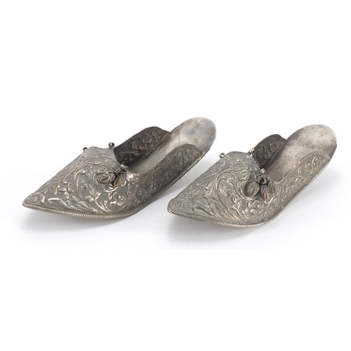 744 - Pair of Middle Eastern unmarked silver slippers, embossed with foliate motifs, each 17cm in length, ... 