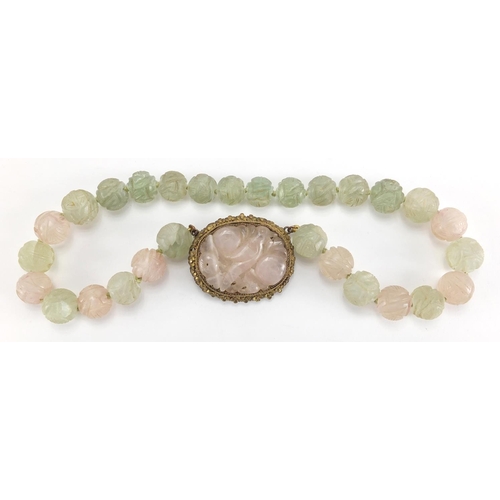 702 - Chinese rose quartz and green hard stone pendant on bead necklace, the pendant set in an unmarked gi... 