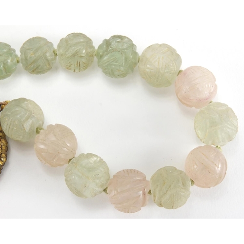 702 - Chinese rose quartz and green hard stone pendant on bead necklace, the pendant set in an unmarked gi... 