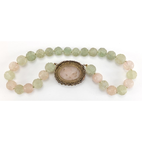 702 - Chinese rose quartz and green hard stone pendant on bead necklace, the pendant set in an unmarked gi... 