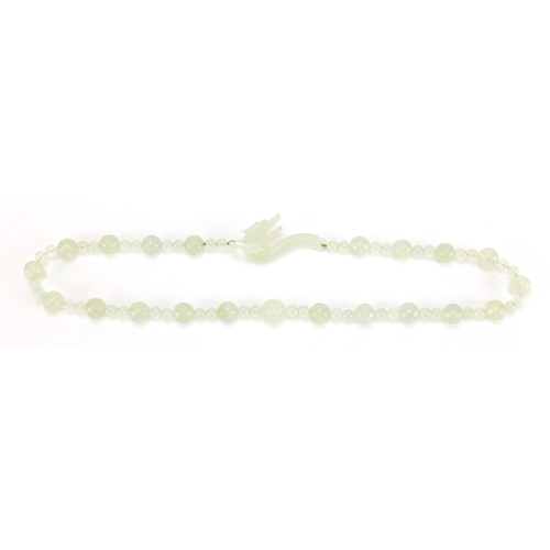 703 - Chinese pale green jade bead necklace, housed in a velvet lined box, 62cm in length