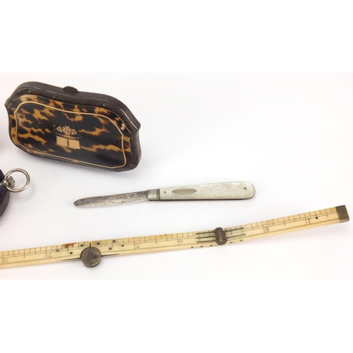 34 - Antique objects comprising a pocket compass with leather case, folding ivory rule, silver bladed mot... 