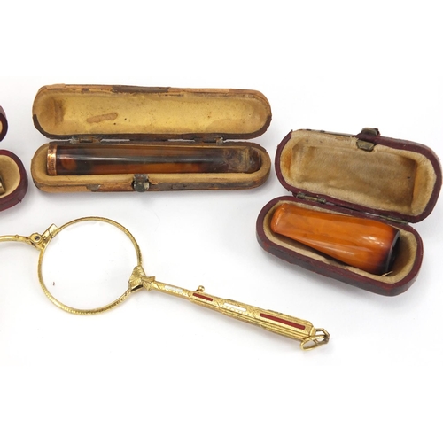 50 - Pair of gilt metal and enamel folding lorgnettes, together with three amber coloured cheroots, one w... 