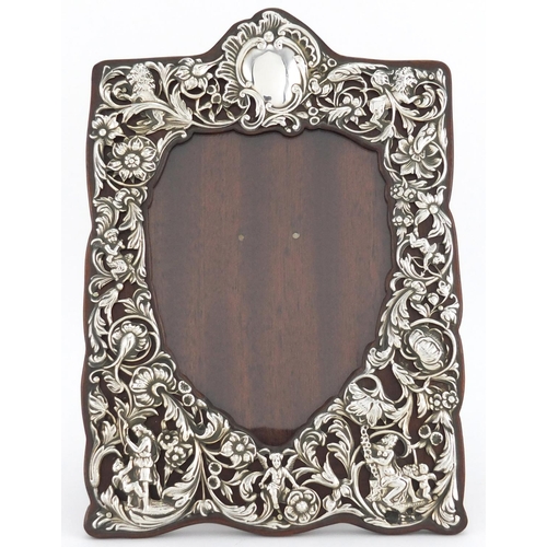 180 - Victorian silver easel photo frame, embossed with maidens, cherubs and lions amongst flowers, by Wil... 
