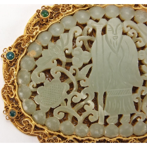 705 - Chinese silver gilt filigree pendant housing a pale green jade panel carved with a figure, animals a... 