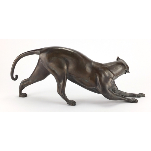 1018 - Modernist patinated bronze study of a crouching leopard, 53cm in length