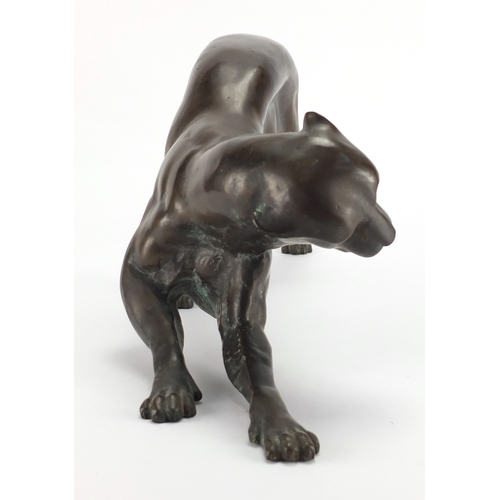 1018 - Modernist patinated bronze study of a crouching leopard, 53cm in length