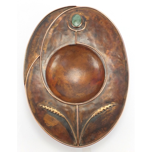 1035 - Sam Fanaroff oval copper and brass dish having an applied flower design, set with a green cabochon, ... 