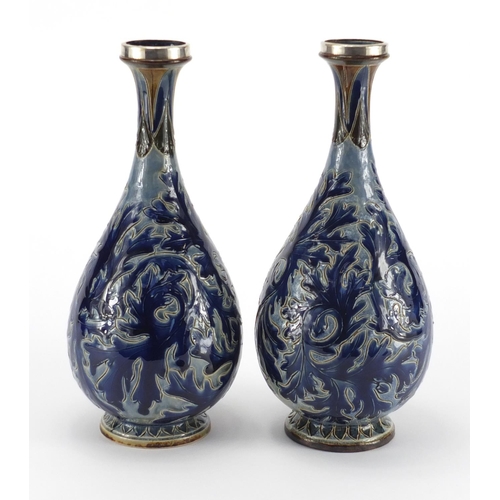 957 - Pair of 19th century Doulton Lambeth vases with unmarked silver rims, incised and hand painted with ... 