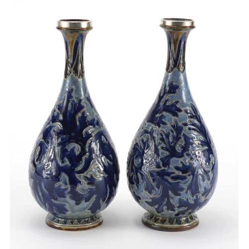 957 - Pair of 19th century Doulton Lambeth vases with unmarked silver rims, incised and hand painted with ... 