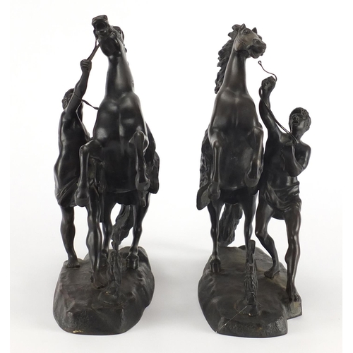 83 - After Guillaume Coustou The Elder - Pair of patinated bronze Marly horses with trainers, the largest... 