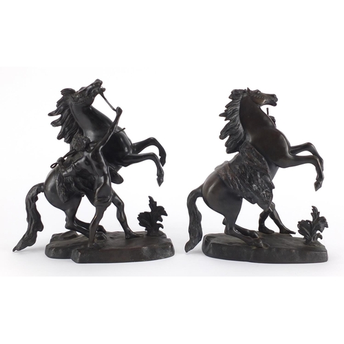 83 - After Guillaume Coustou The Elder - Pair of patinated bronze Marly horses with trainers, the largest... 