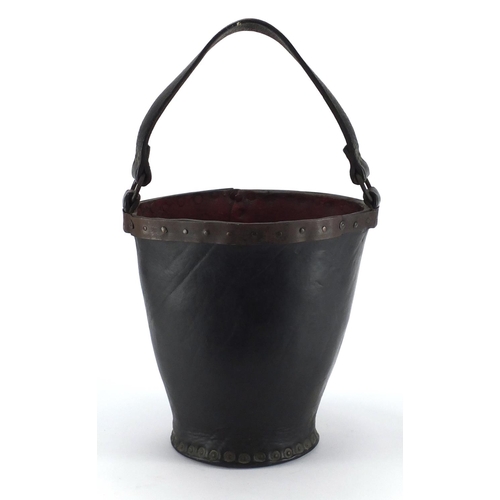 103 - Antique metal studded leather fire bucket, 31cm high excluding the handle