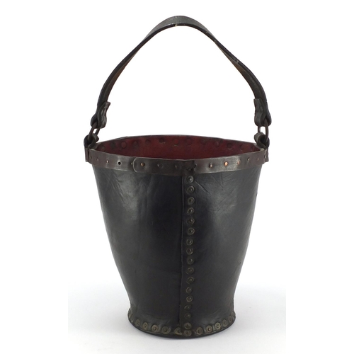 103 - Antique metal studded leather fire bucket, 31cm high excluding the handle