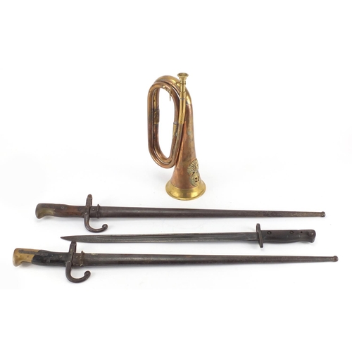 488 - Three Military interest bayonets and a copper and brass bugle with Royal Welsh Fusilier badge, vario... 