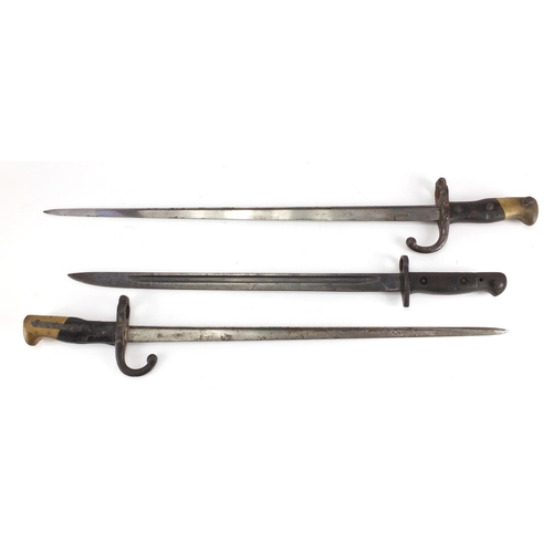 488 - Three Military interest bayonets and a copper and brass bugle with Royal Welsh Fusilier badge, vario... 