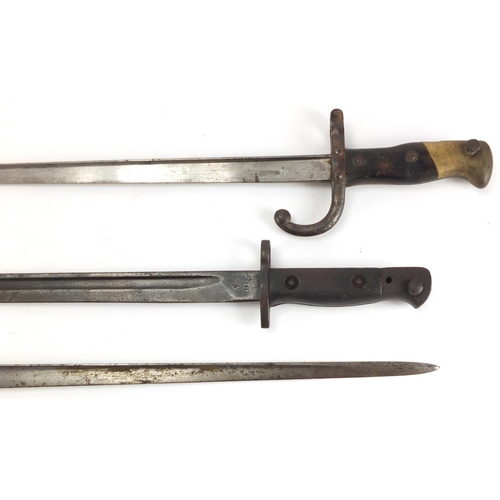 488 - Three Military interest bayonets and a copper and brass bugle with Royal Welsh Fusilier badge, vario... 