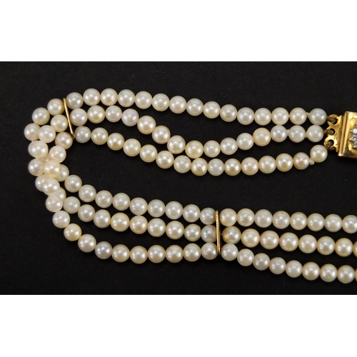 1051 - Three row pearl necklace with 18ct gold sapphire and diamond clasp, 32cm in length, approximate weig... 