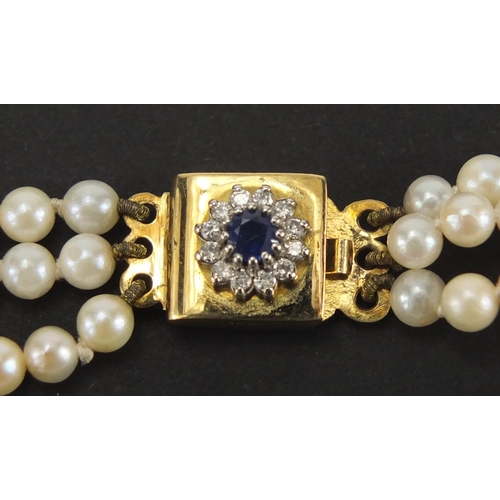 1051 - Three row pearl necklace with 18ct gold sapphire and diamond clasp, 32cm in length, approximate weig... 