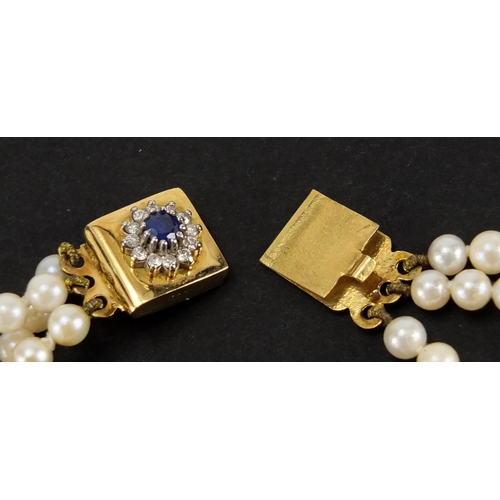 1051 - Three row pearl necklace with 18ct gold sapphire and diamond clasp, 32cm in length, approximate weig... 