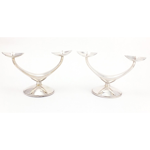211 - Pair of Danish silver two branch candelabra, each stamped 835 WTB, 11cm high x 19cm wide, approximat... 