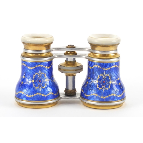 23 - Pair of brass and Mother of Pearl opera glasses, the guilloche enamelled jewelled barrels decorated ... 
